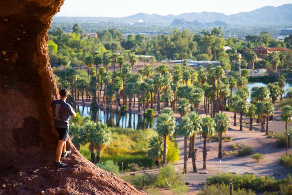 Man looking at the view from the hole in the rock in Phoenix, AZ